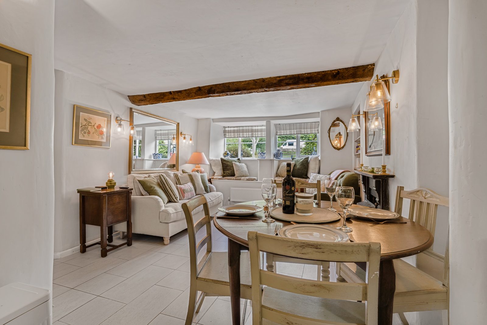 Dining table laid for four at Green Hideaway with the living room behind