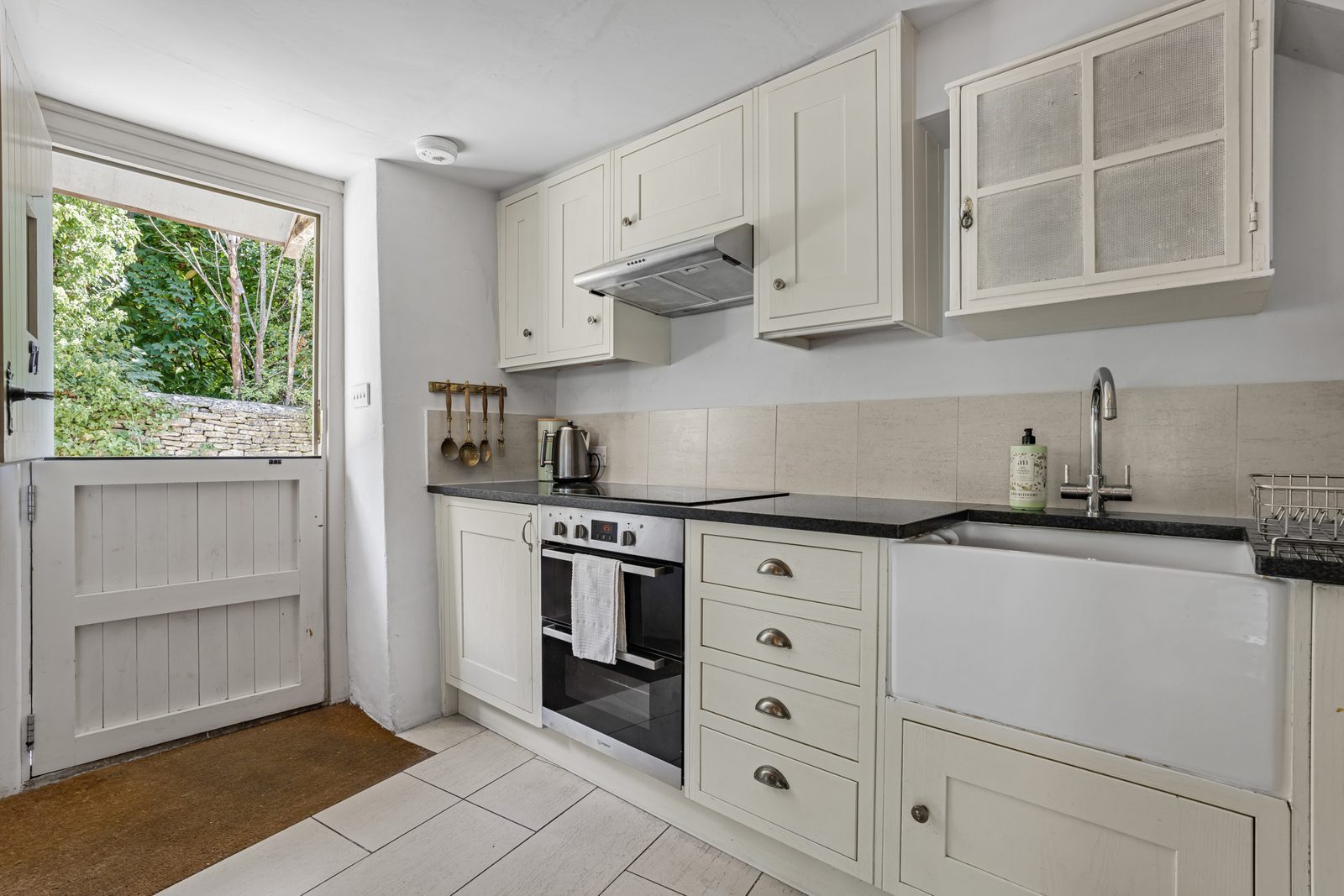 Stable door open from the kitchen at Green Hideaway onto the garden