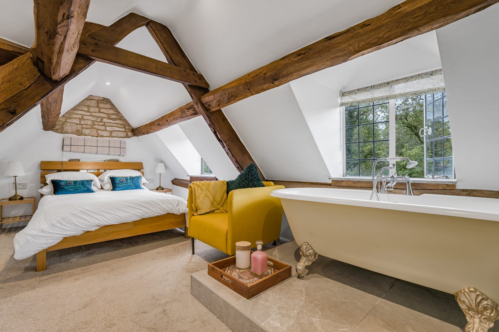 Beamed attic bedroom at Riverside Cottage with king-size bed and roll-top bath