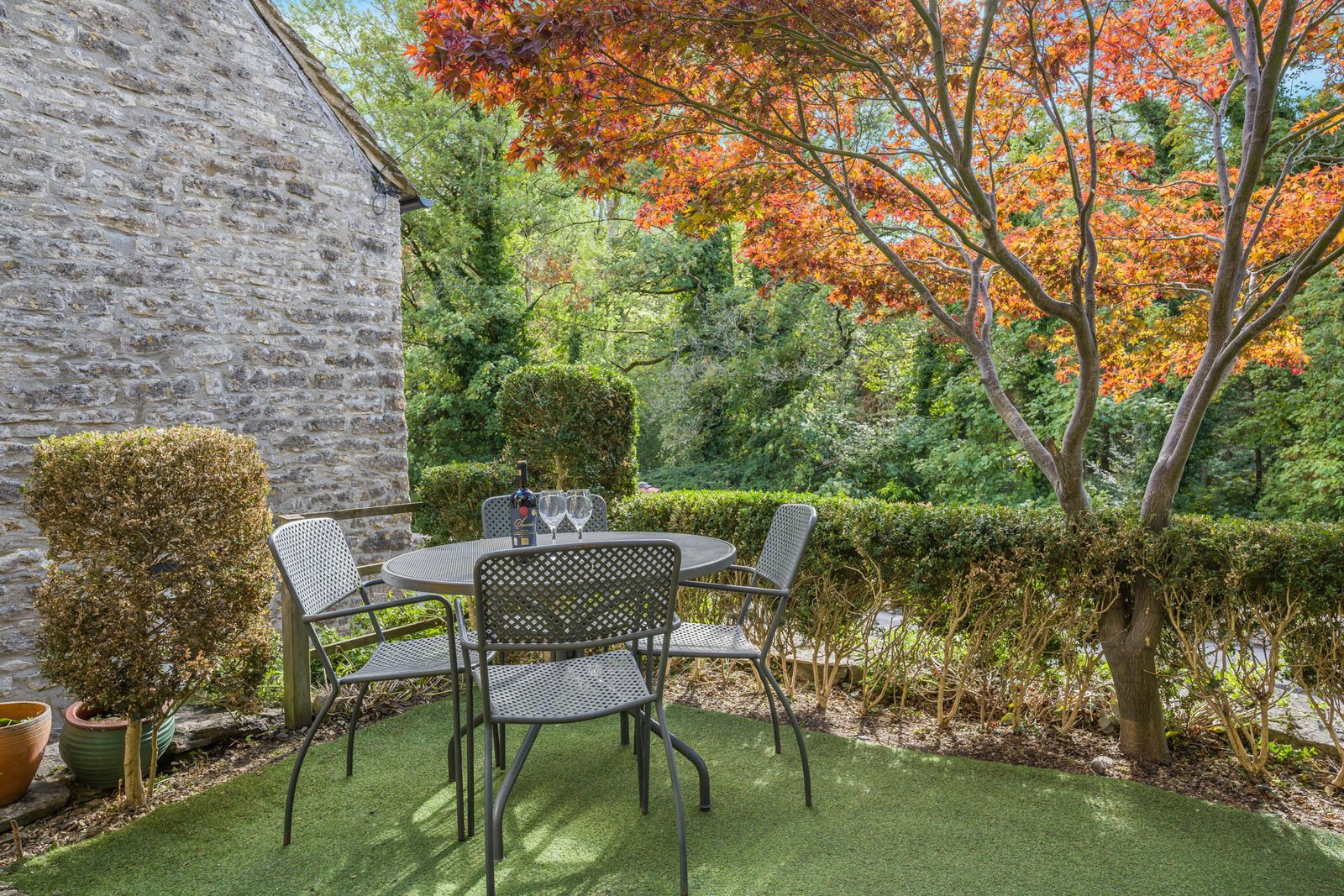 Riverside Cottage terrace with red acer tree