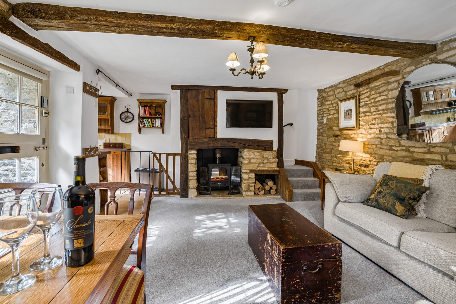 Woodburner set in the stone chimney breast in the living room at Riverside Cottage