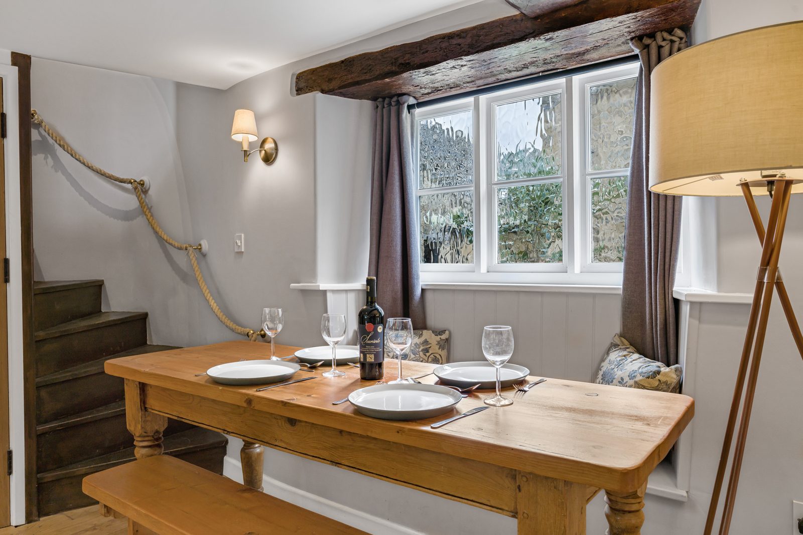 Long oak dining table and bench at Rosemary Cottage below the stairs