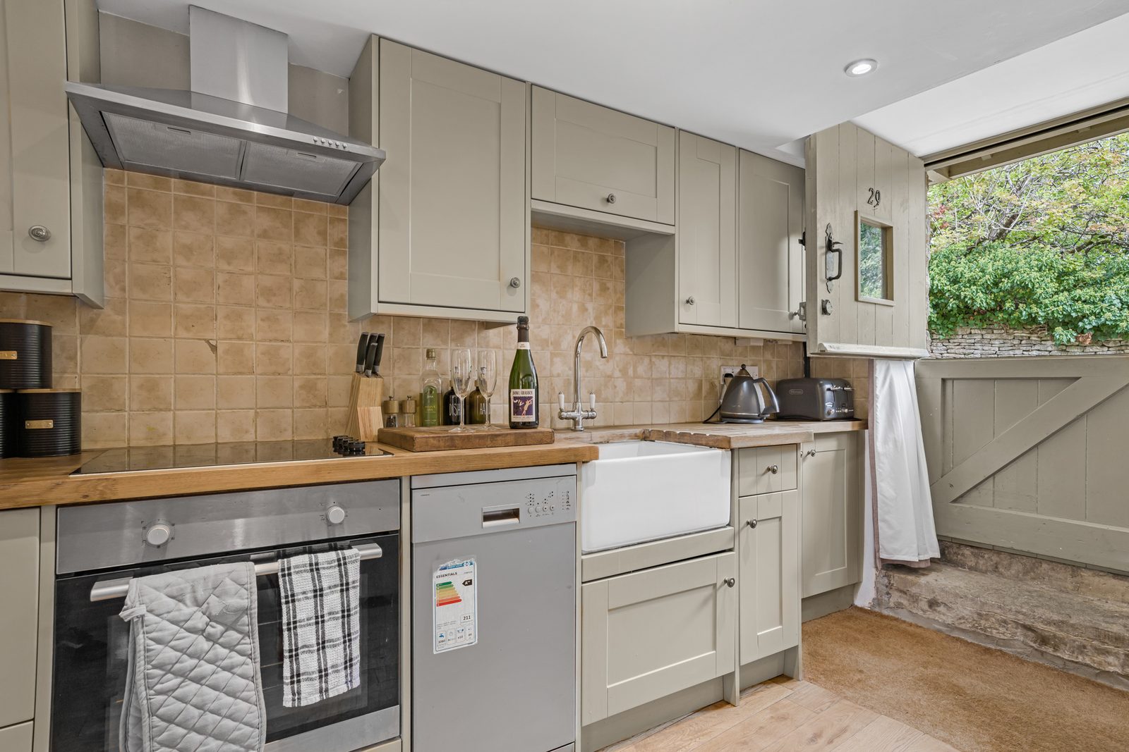 Grey shaker kitchen at Rosemary Cottage with Belfast sink and wood worktop