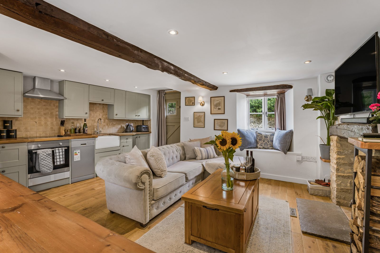 Open plan living room and kitchen at Rosemary Cottage with oak floor and beams